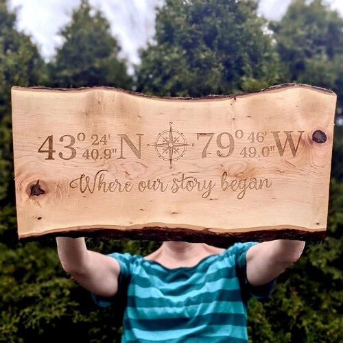 Large live edge charcuterie board engraved with compass coordinates of a meaningful place.