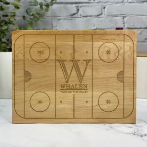 Cutting boards engraved with a hockey rink design can be personalized in the center to thank your coach.