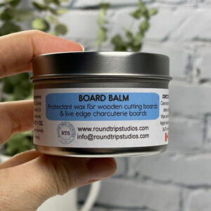 A container of Board Balm - used to care for wood cutting and charcuterie boards