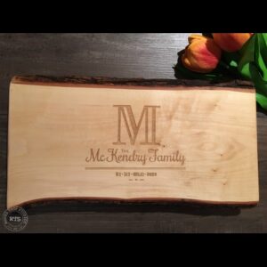 Charcuterie board with a live wood edge engraved with initial design engraved.