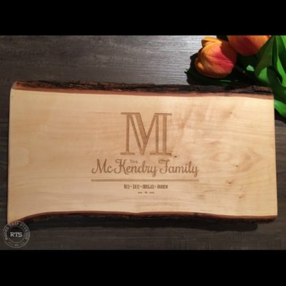 Live edge charcuterie board with initial design engraved.