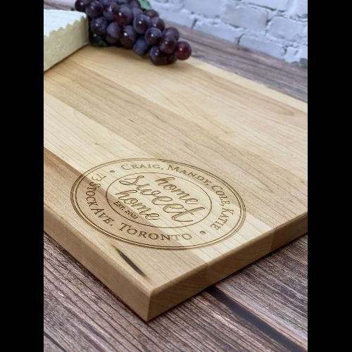 Tuscan home sweet home engraved in the corner of a rectangular cutting board.