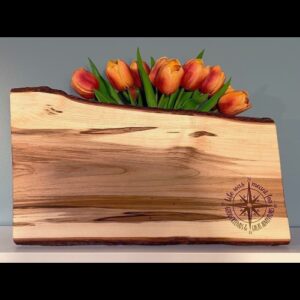 Customized charcuterie board with compass engraved in the corner.
