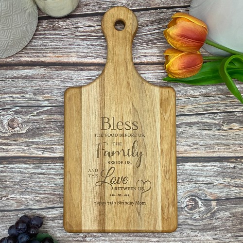 Custom cutting board with bless the food before us saying engraved.