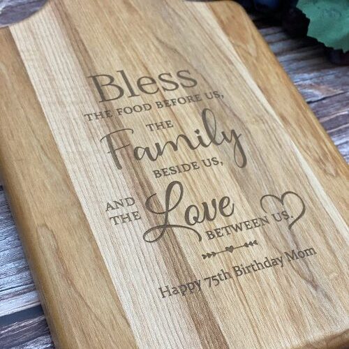 Wood cutting boards engraved with bless this food, family and love saying.