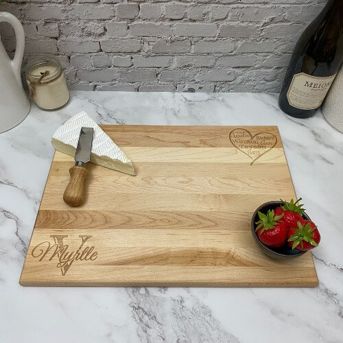 Engraved rectangular cutting board with an initial and name in one corner.