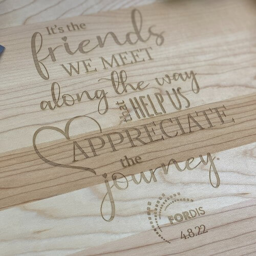 Engraved cutting board with "it's the friends we meet along the way that help us appreciate the journey."