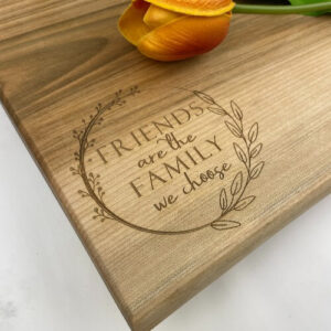 This maple charcuterie board is engraved with a saying that makes it a great gift for friends.