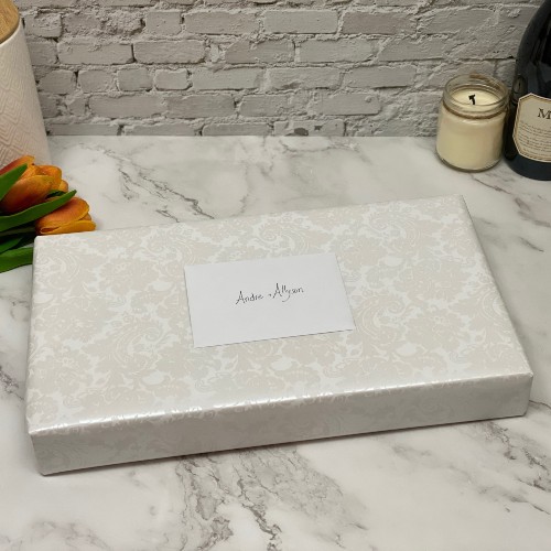 Gift wrapped in wedding wrapping paper with handwritten card.
