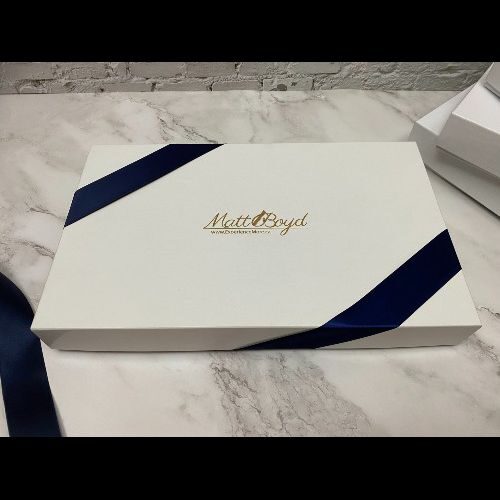 Gift box with Realtor logo engraved and navy ribbon.