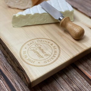 Charcuterie board personalized for a wedding with engraving in the corner.