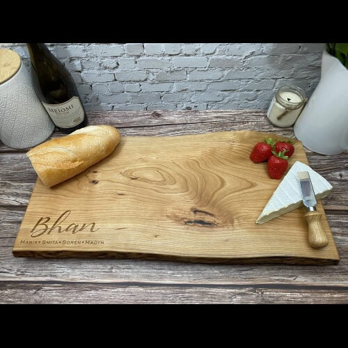 Live edge charcuterie board with personalized engraving.