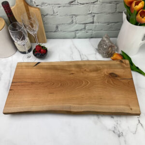 A cherry charcuterie board that can be engraved in the center or the corner.
