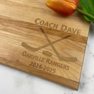 Engraved cutting board for a hockey coach.